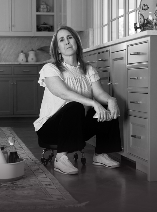 Ambassador Kerri, who has LOPD, sitting on a rolling stool