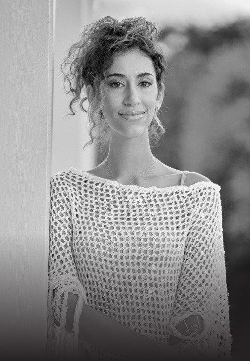 Ambassador Veronica, who has LOPD, standing and smiling at the camera