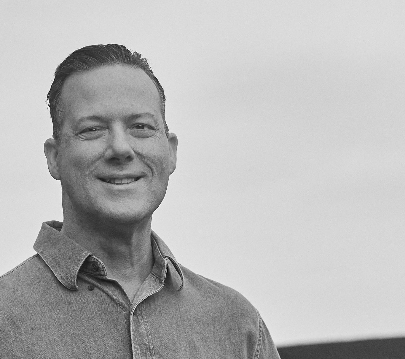 Ambassador Scott, who has LOPD, standing outside and smiling at the camera