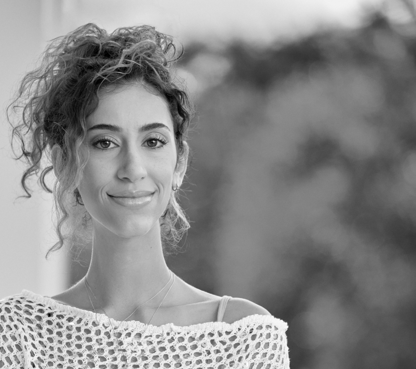 Ambassador Veronica, who has LOPD, standing and smiling at the camera