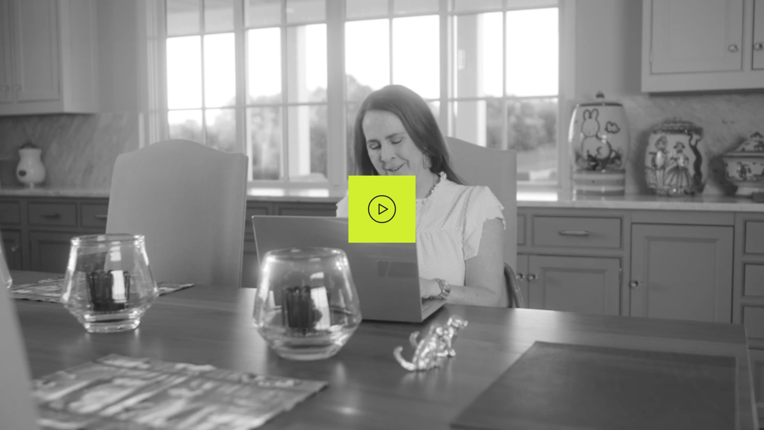 Ambassador Kerri, who has LOPD, typing on her laptop in a kitchen