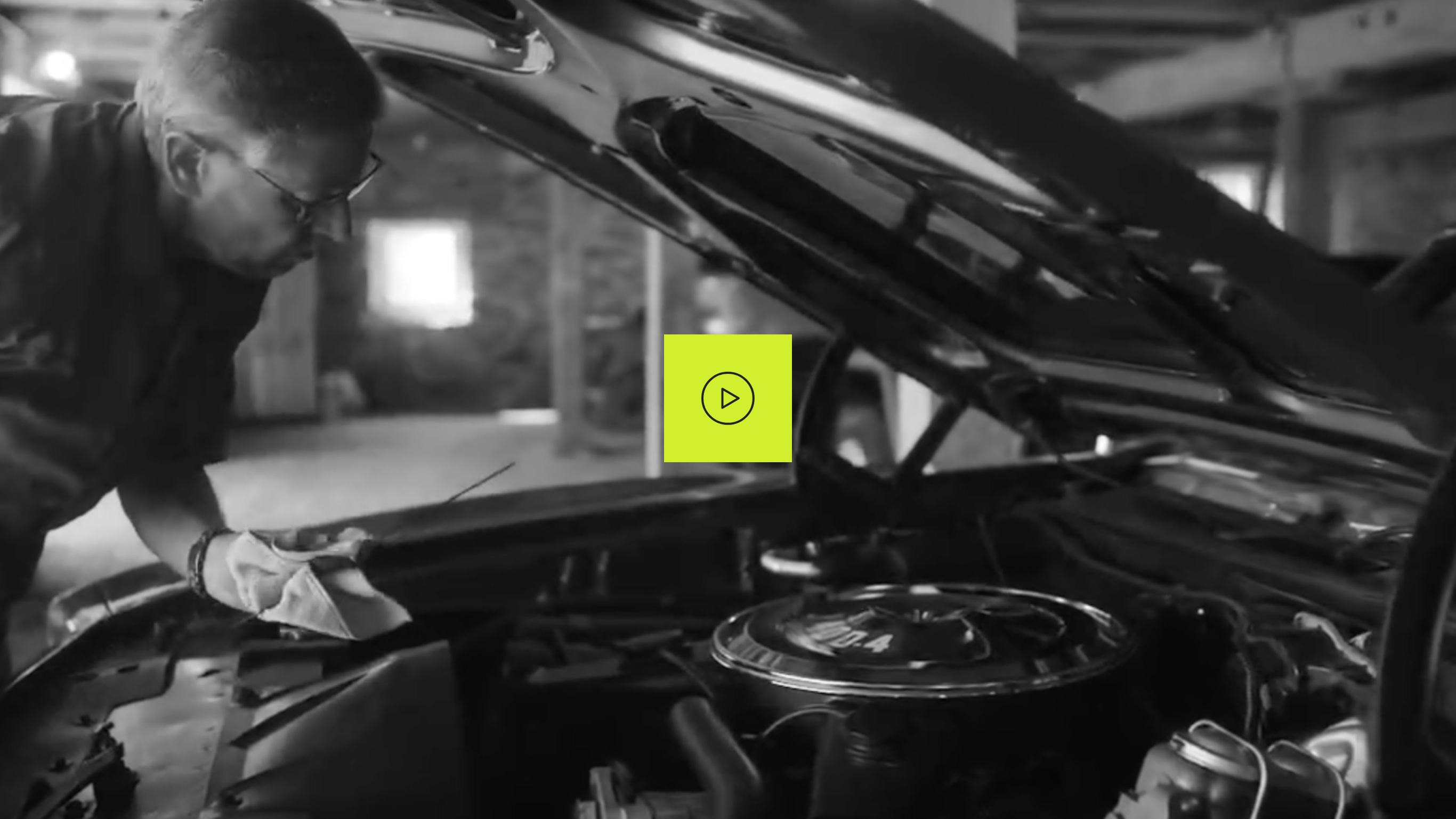 Ambassador Michael, who has LOPD, under the hood of a car checking the oil